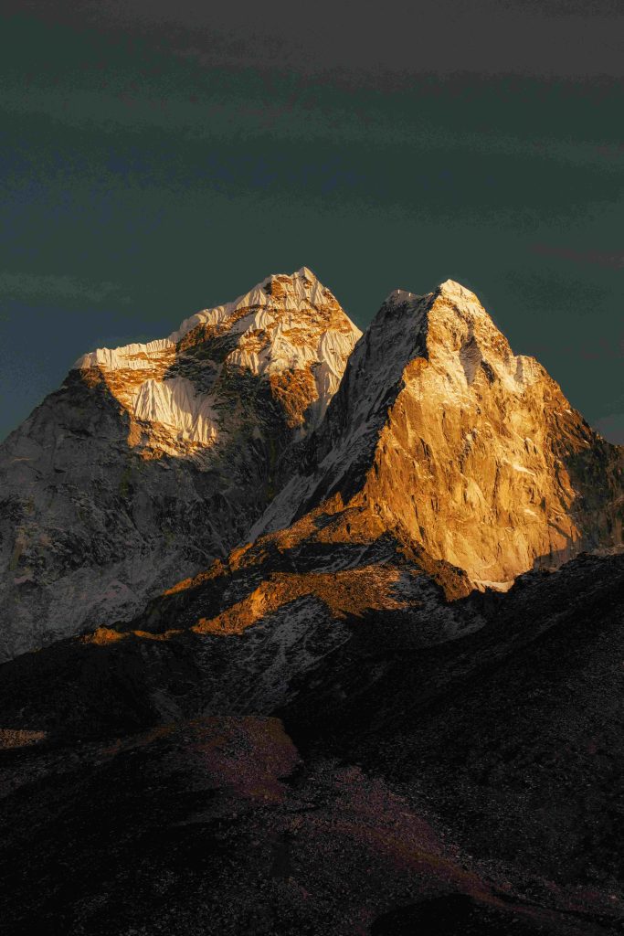 Golden sunset light bathes the majestic peaks of the Himalayas, creating a stunning natural spectacle. sunrise view of everest base camp makes it golden color more beautiful.