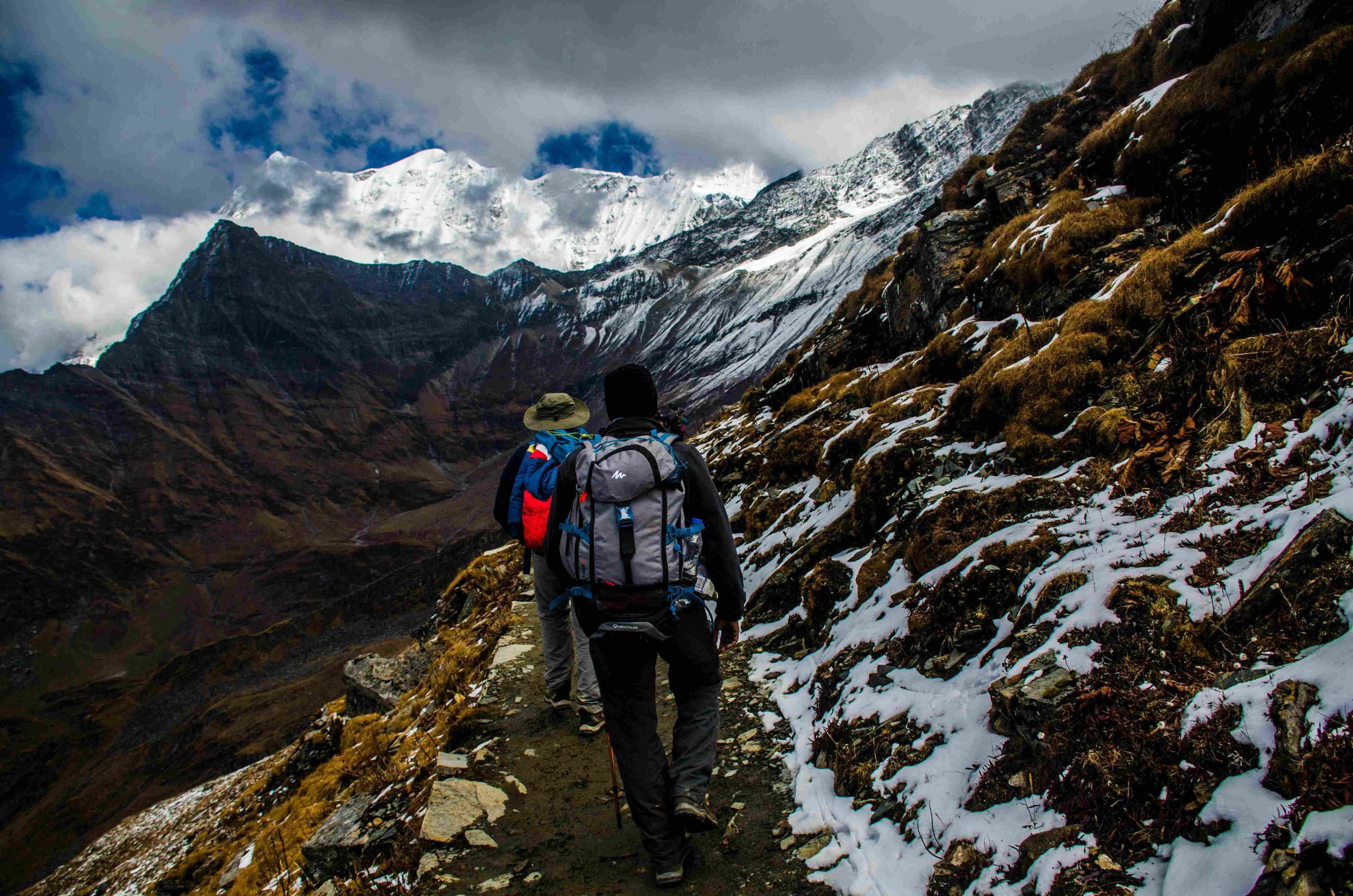 Two person rekking in nepal in the mountain region. big mountains and hills are seen in a view.