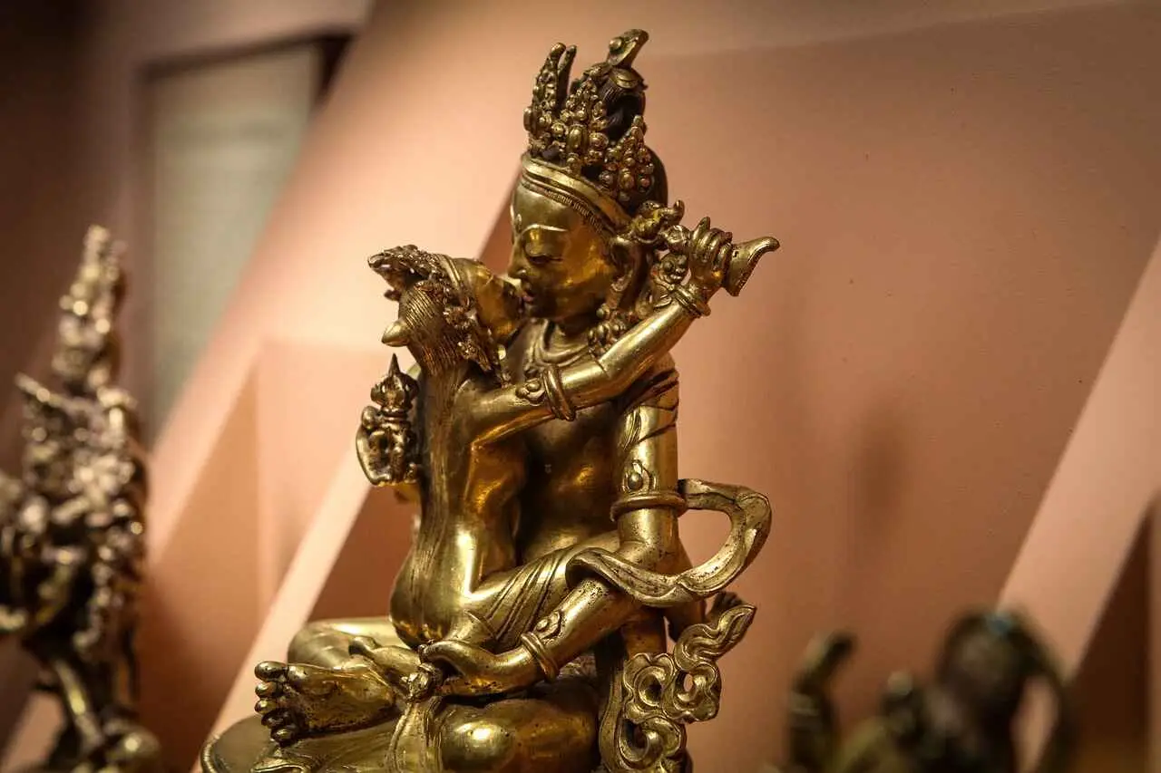 Statue of two figures associated with Vamachara tantra. the statue is linked with each other and is golden in color