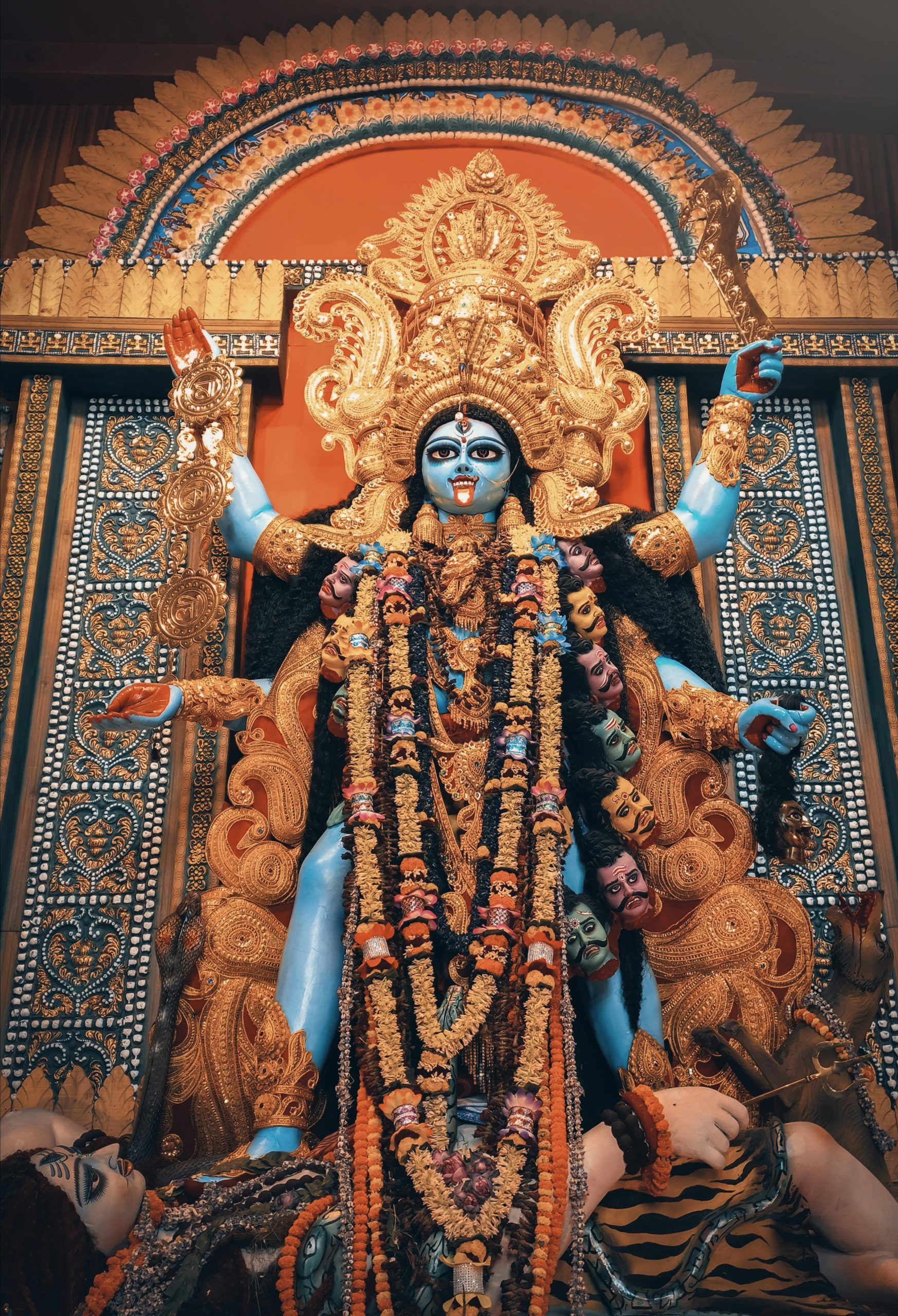 Intricately decorated Kali idol during a colorful festival in Kolkata, India.