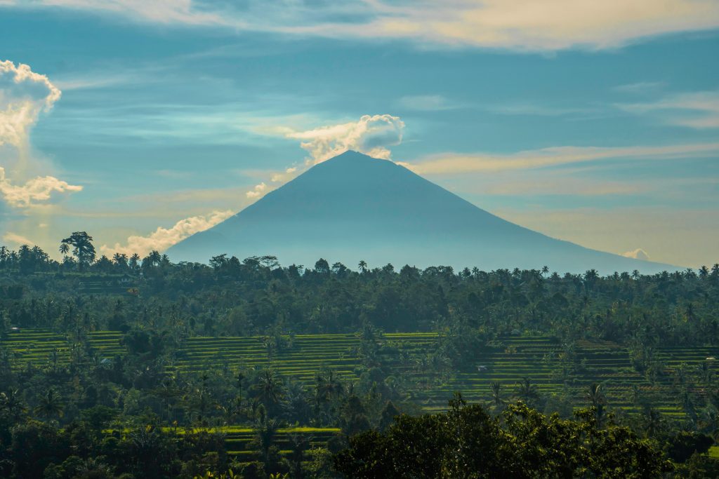 Stunning view of a volcano amidst lush greenery in Lampung, Indonesia. Perfect for nature lovers.