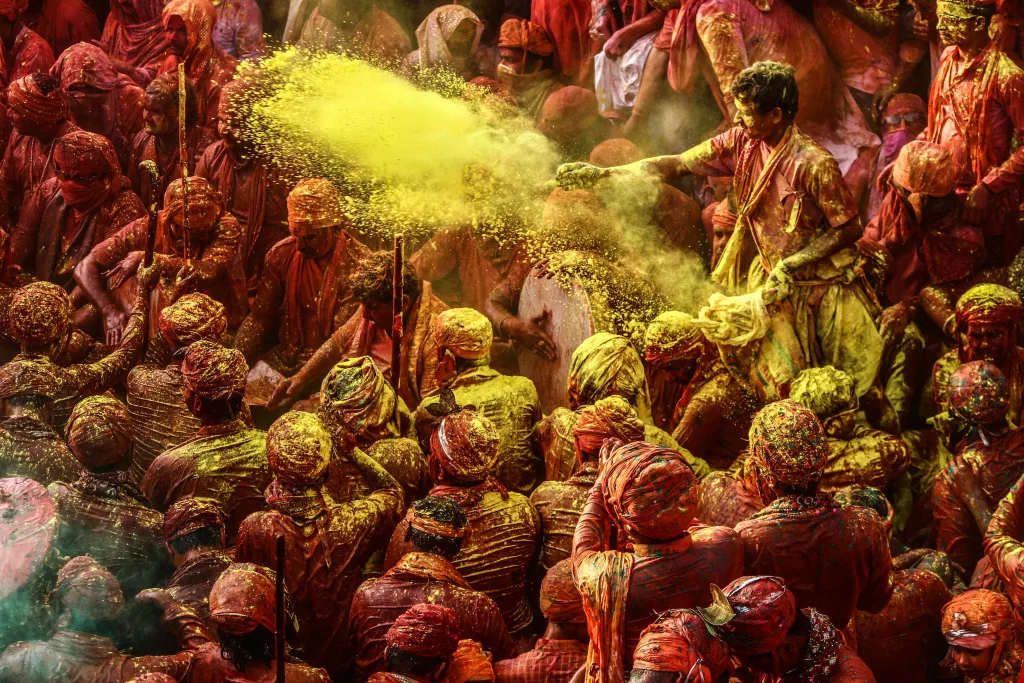 Crowd celebrate Holi in kathmandu 2025 with colorful powders in vibrant outdoor setting.