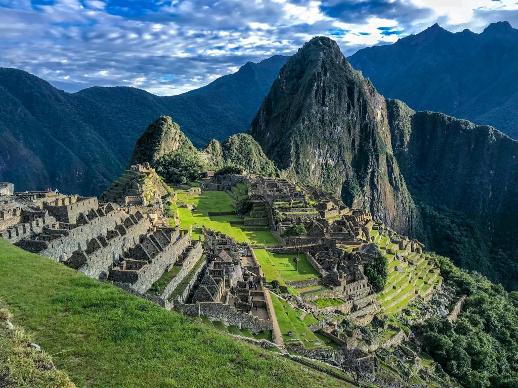 Explore the stunning ancient ruins of Machu Picchu, a UNESCO World Heritage Site in Peru, surrounded by majestic mountains.