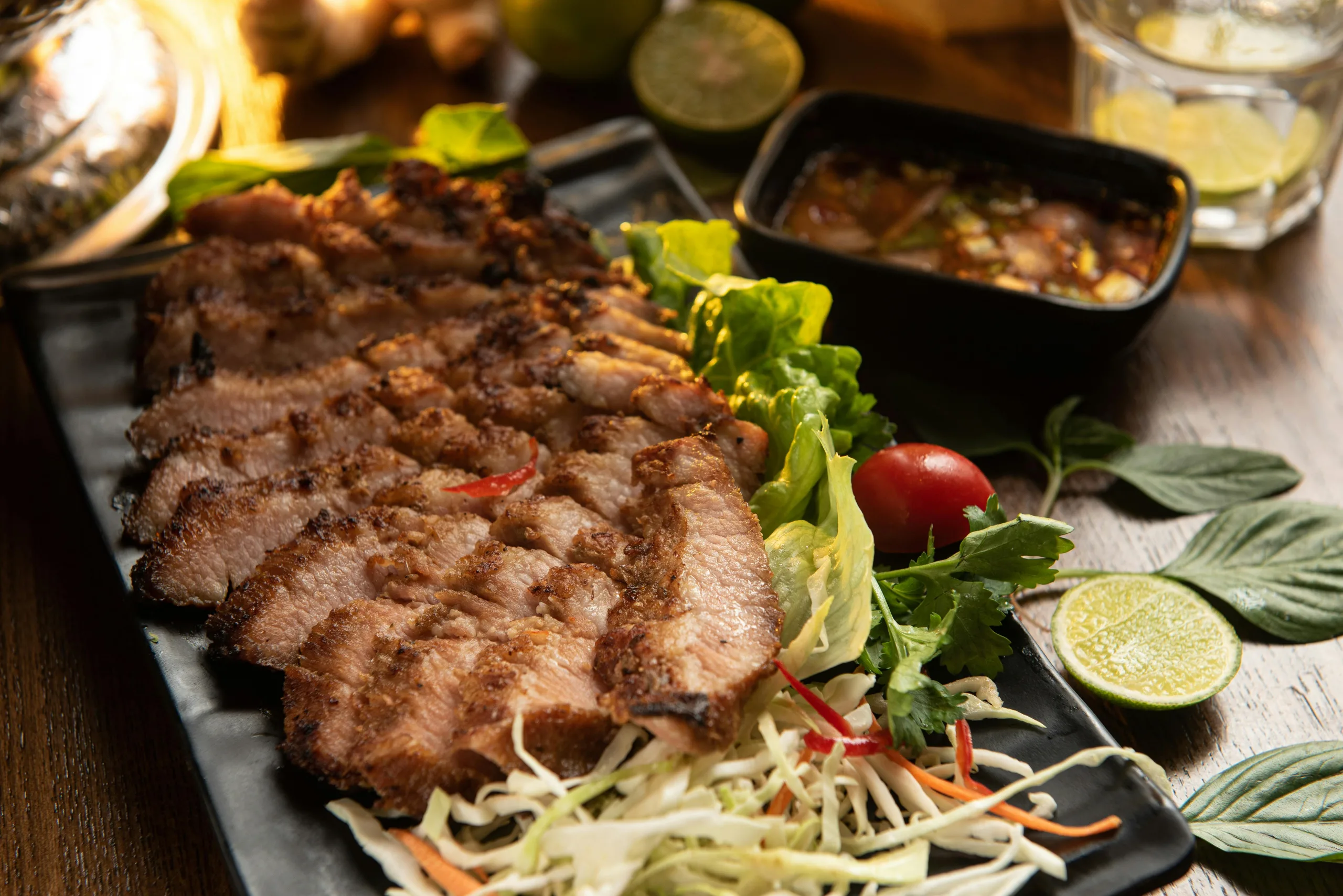 Delicious grilled pork served with fresh vegetables and a spicy dipping sauce.