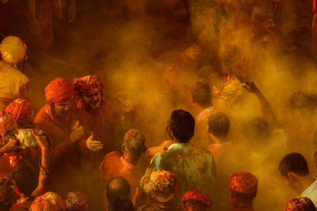 Colorful and energetic Holi celebration with joyful crowd immersed in vibrant powder.