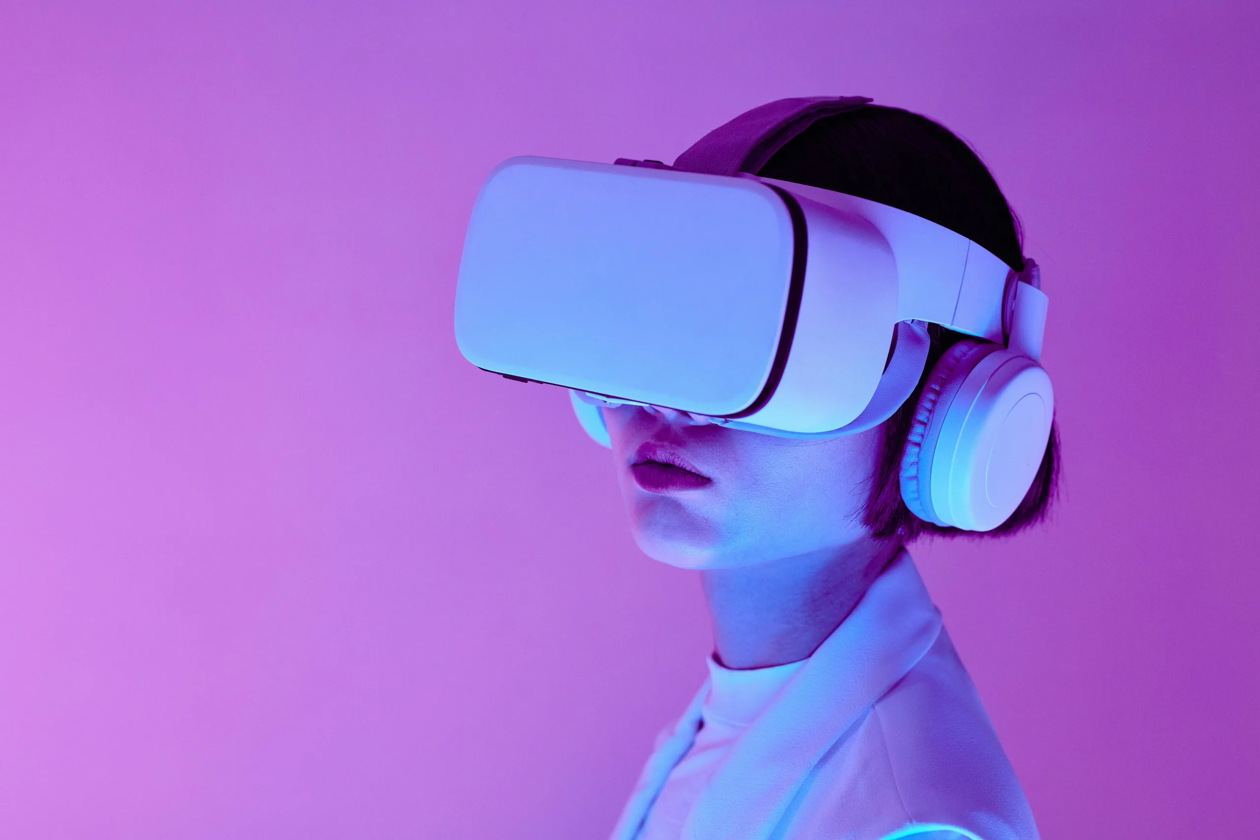 Woman explores virtual reality with VR goggles in modern studio light.